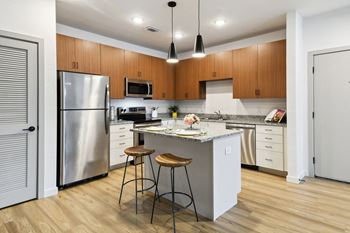 a kitchen with a island and two stools